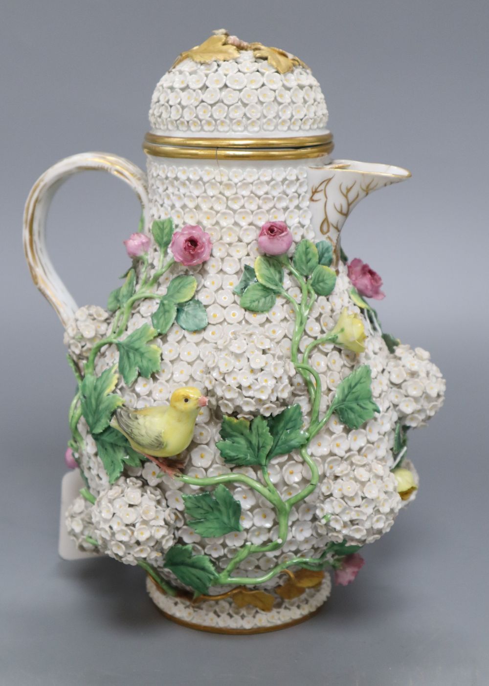 A Meissen floral encrusted hot water jug and cover, height 26cm